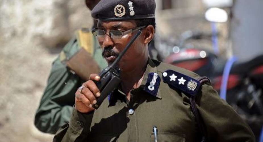 A Somali police officer talks on a radio in Mogadishu on November 13, 2013.  By Mohamed Abdiwahab AFPFile