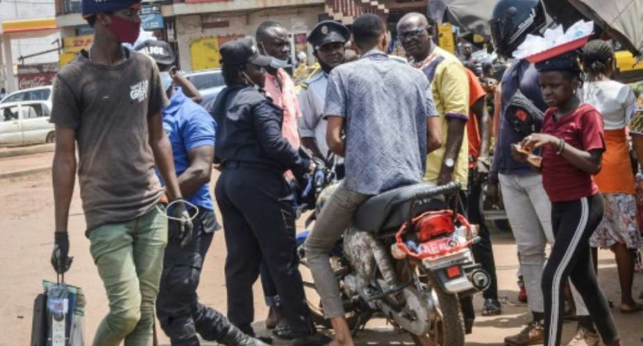 Two wheels bad: Police stop a motorcycle taxi driver in Conakry.  By CELLOU BINANI AFP
