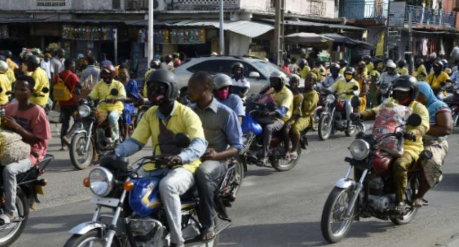 Two wheels good: Benin's motorbike taxis play a key role in election campaigns.  By PIUS UTOMI EKPEI AFP
