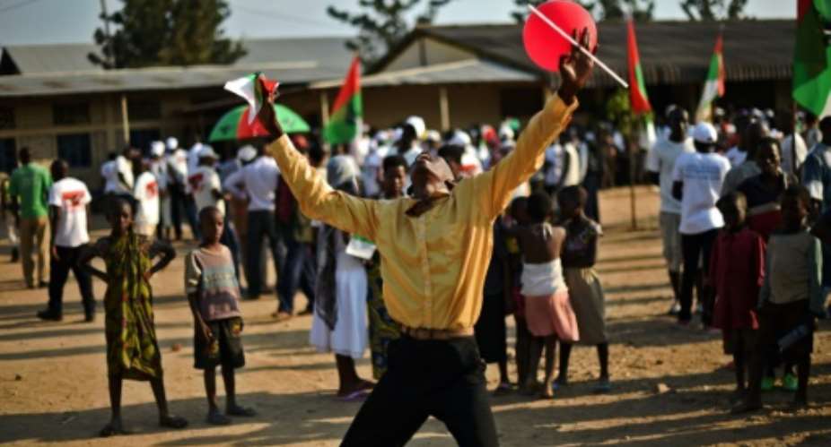 A man dances at a CNDD National Council for the Defense of Democracy–Forces for the Defense of Democracy political party rally in Bujumbura on July 16, 2015, ahead of elections on July 21, 2015.  By Carl De Souza AFP