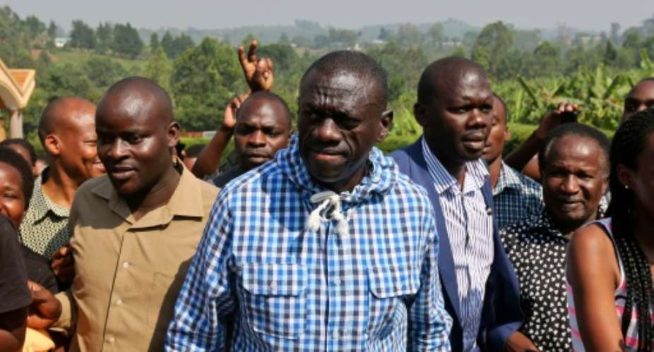 Uganda's opposition leader Kizza Besigye arrives at a polling station to vote in his home town of Rukungiri, on February 18, 2016.  By  AFP