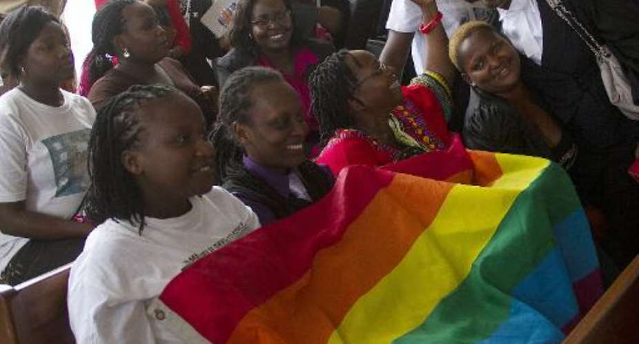Members of Uganda's gay community and gay rights activists react as the constitutional court overturns anti-gay laws, in Kampala, on August 1, 2014.  By Isaac Kasamani AFPFile
