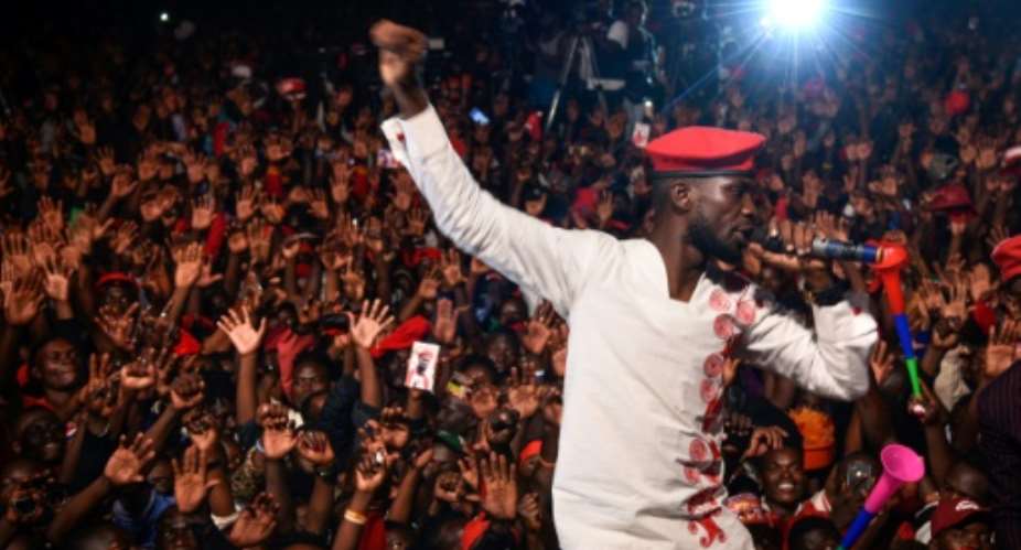 Ugandan musician-turned-politician Bobi Wine had been due to perform a gig near Kampala when police raided his hotel, his lawyer said.  By Isaac KASAMANI AFPFile