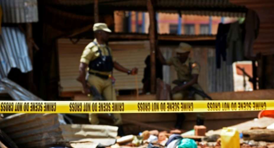 Ugandan police officers secure the cordoned off site following a joint Uganda Police Force and Army security operation upon a radicalisation centre at the Kampala Usafi mosque on April 28, 2018.  By ISAAC KASAMANI AFP