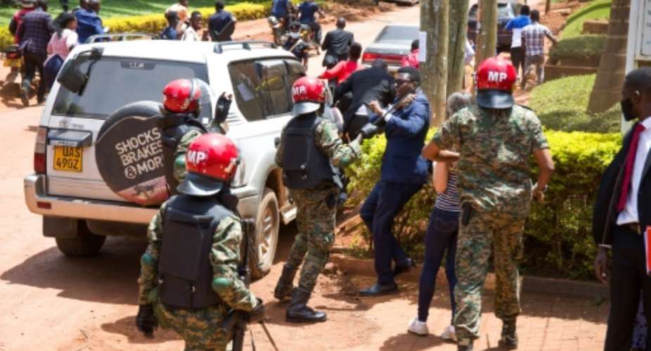 Ugandan security forces beat journalists covering Bobi Wine filing a petition with the UN against human rights abuses.  By Badru KATUMBA AFP