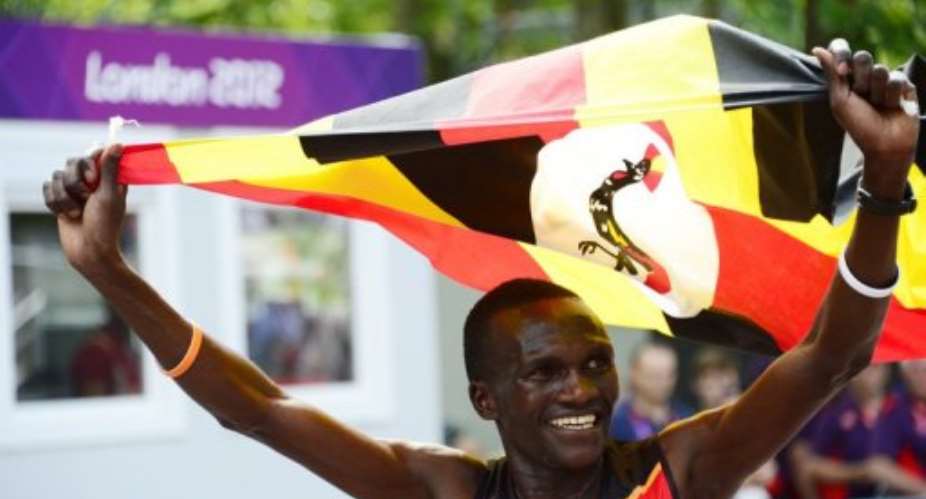 Uganda's Stephen Kiprotich crossed the finish line waving his national flag.  By Daniel Garcia AFP