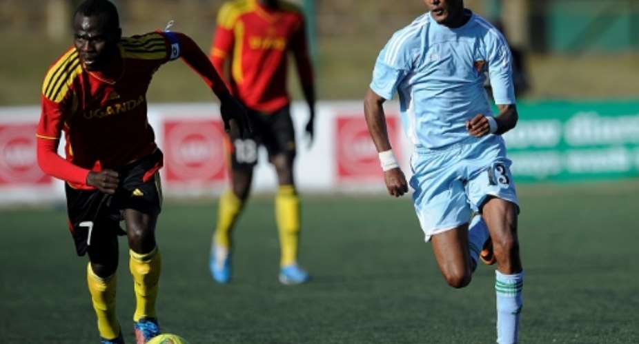 Uganda's Emmanuel Okwi L runs with the ball next to Eritrea's Selemon Yonatan during a Council for East and Central Africa Football Associations CECAFA Cup football match in Nairobi, on December 2, 2013 in Nairobi.  By SIMON MAINA AFPFile
