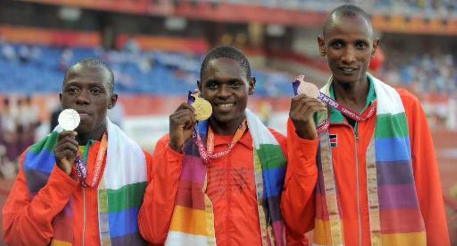 left to right Kenya's Daniel Salel silver, Uganda's Moses Kipsiro gold and Kenya's Joseph Birech bronze on the podium after the Commonwealth Games men's 10,000m final on October 12, 2010 in New Delhi.  By Manan Vatsyayana AFP