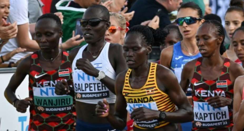Ugandas Rebecca Cheptegei (centre, yellow shirt) was assaulted at her home in Kenya, police said.  By Ferenc ISZA (AFP)
