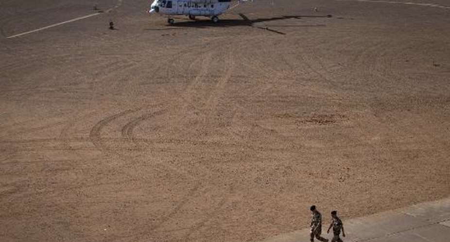 French soldiers walk near a UN helicopter on December 31, 2013 at the French military base in Gao, northern Mali.  By Joel Saget AFPFile