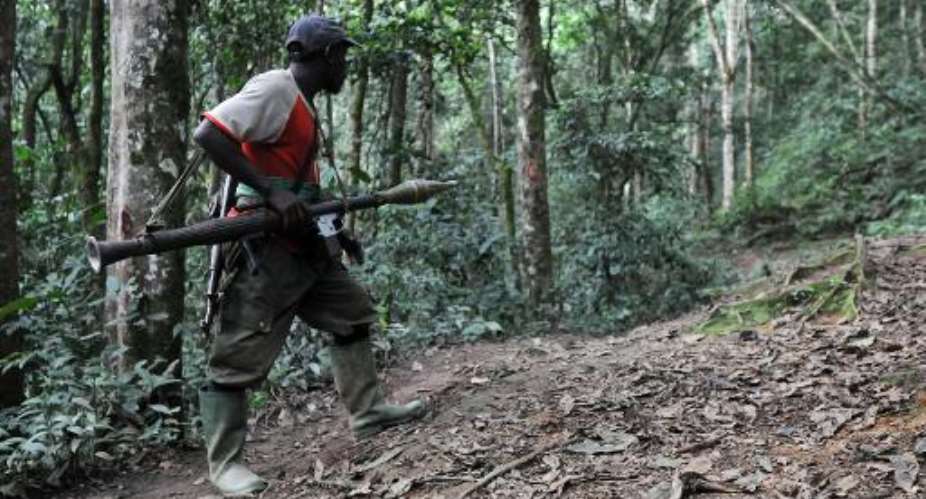 A Rwandan Hutu rebel of the Democratic Force for the Liberation checks a path in a dense forest on February 6, 2009 outside Pinga, Democratic Republic of Congo.  By Lionel Healing AFPFile