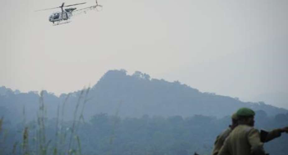 A UN helicopter flies over the Virunga National Park, around 20 kms from Goma on July 11, 2012.  By Phil Moore AFP