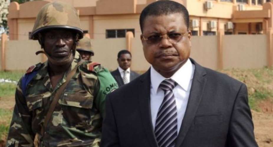 Central Africa's Prime Minister Nicolas Tiangaye R, flanked by a FOMAC soldier in Bangui on March 29, 2013.  By Sia Kambou AFPFile