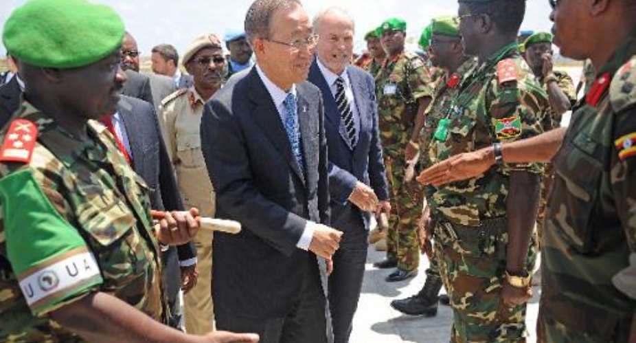 Ban Ki-moon centre is welcomed by African Union Mission in Somalia AMISOM officers, on October 29, 2014 as he arrives in Mogadishu.  By Mohamed Abdiwahab AFP