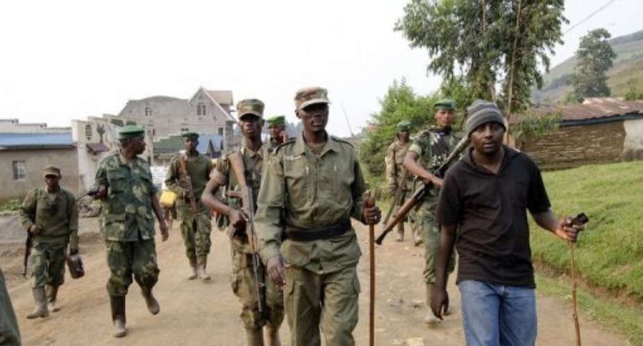 Colonel Sultani Makenga (C), head of the rebel M23 group, tours Bunagana, a town near the Ugandan-DR Congo border.  By Michele Sibiloni (AFP/File)
