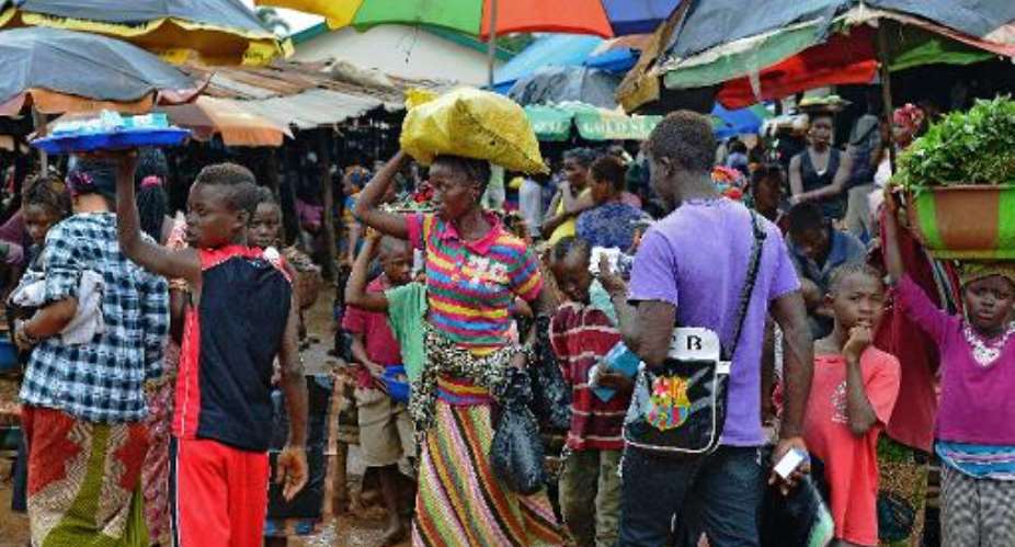 People walk in a market in Kenema, Sierra Leone, on August 16, 2014.  By Carl de Souza AFPFile