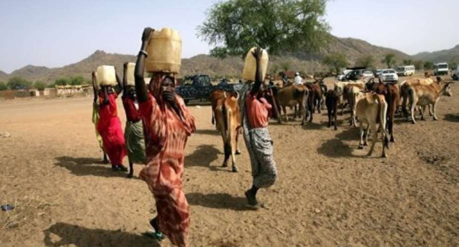 Sudanese women carry water in the town of Kadugli in the northern state of South Kordofan in 2011.  By Ashraf Shazly AFPFile