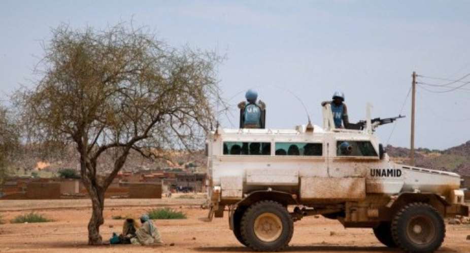 UN peacekeepers escort a humanitarian operation in the North Darfur town of Kutum on August 9, 2012.  By Albert Gonzalez Farran UNAMIDAFPFile