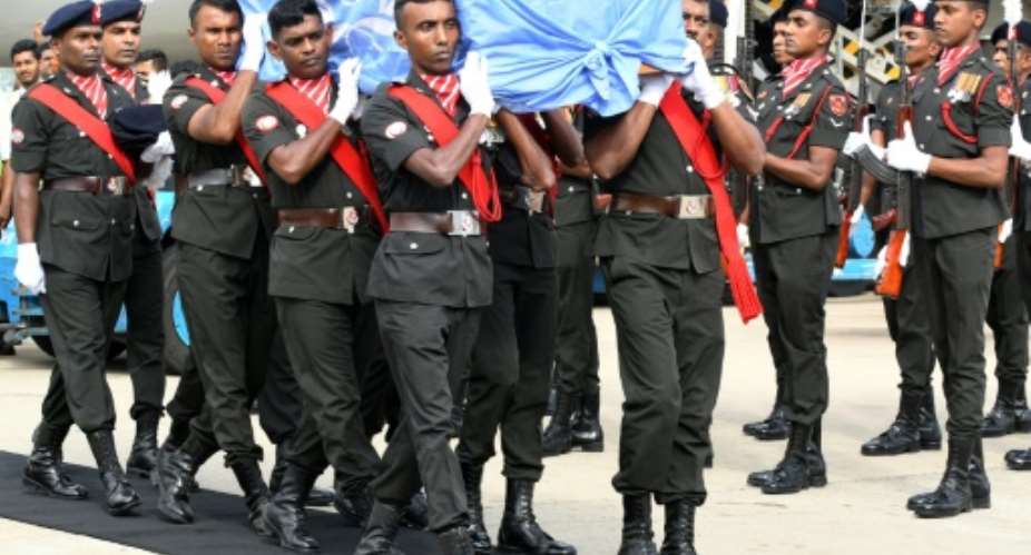 UN peacekeepers from Sri Lanka carry the coffin of a Sri Lankan soldier killed in an attack on a convoy in Mali.  By LAKRUWAN WANNIARACHCHI AFPFile