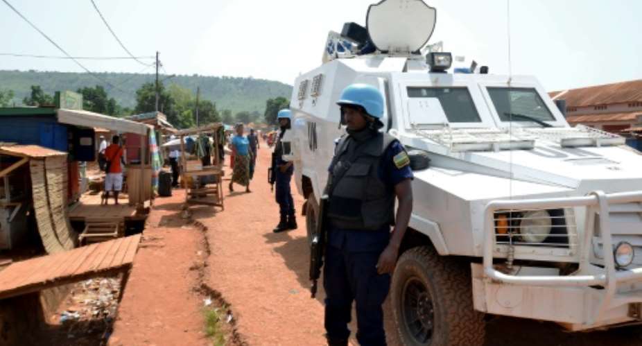 Rwandan policemen from the United Nations Multidimensional Integrated Stabilization Mission in the Central African Republic MINUSCA patrol the market streets at Boy Rabe neighborhood on May 22, 2015 in Bangui.  By Patrick Fort AFPFile