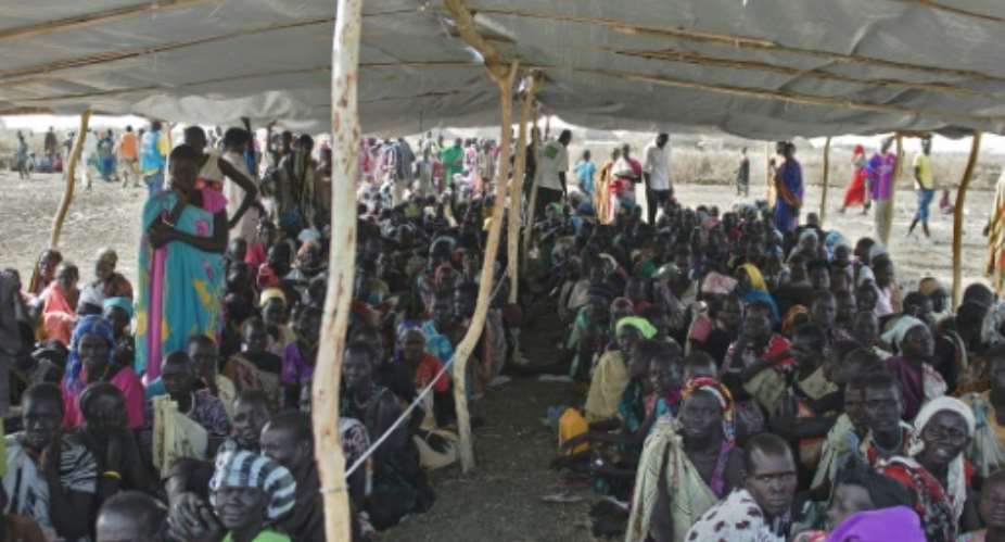 IDPs Internally displaced persons wait to receive food rations at the UNMISS  site in Bentiu, Unity State, on February 27, 2015.  By Charles Lomodong AFP