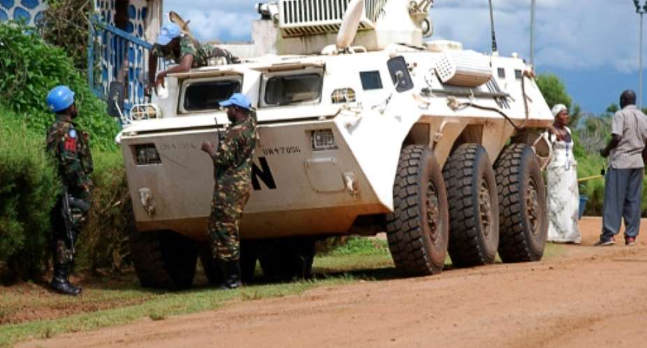 Members of the United Nations Organization Stabilization Mission in the Democratic Republic of Congo MONUSCO stand near a UN armoured vehicle in Beni on October 23, 2014.  By Alain Wandimoyi AFPFile