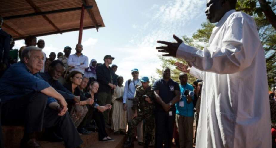 UN Secretary General Antonio Guterres, left, listens to Ali Idriss, the Muslim community leader at the Bangassou camp for displaced persons. People there live in daily fear of being attacked by the 'anti-balaka' militia.  By ALEXIS HUGUET AFP