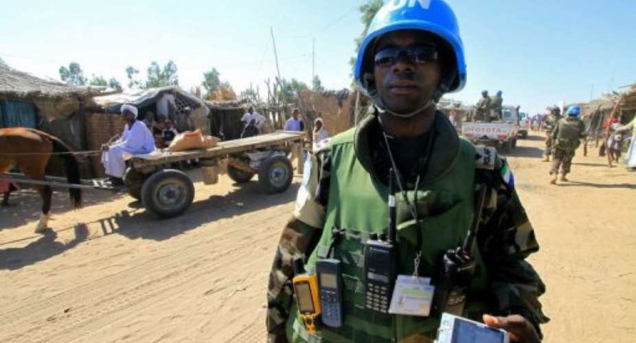 A United Nations peacekeeper patrols a market.  By Ashraf Shazly (AFP/File)