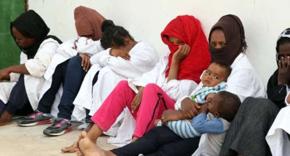 Migrants who were hoping to reach Europe by boat sit at Abu Salim detention centre for illegal migrants in the Libyan capital Tripoli on April 21, 2015.  By Mahmud Turkia AFPFile