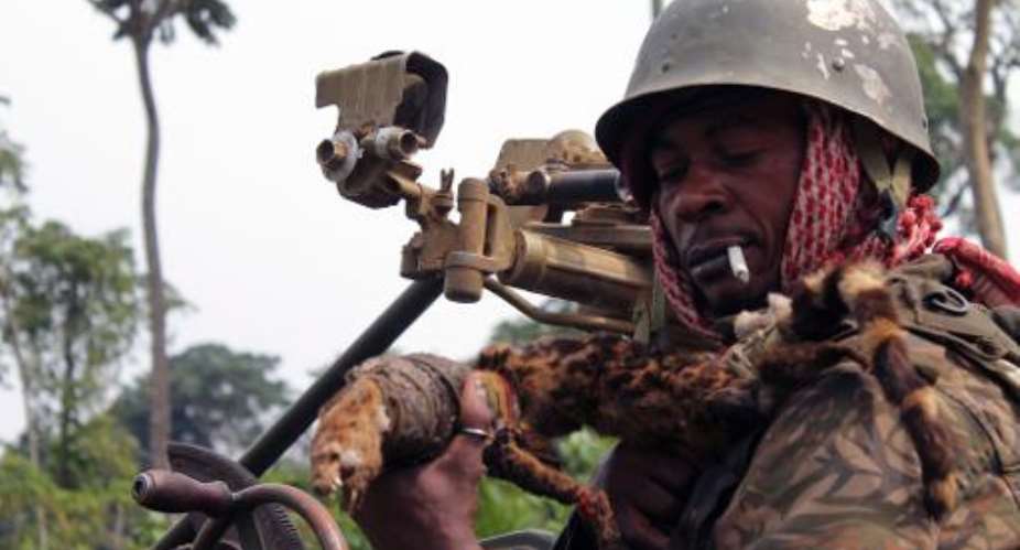 A Democratic Republic of Congo government soldier prepares to go into action against rebels of the ADF-Nalu, a Ugandan Islamist group, near Kokola, in the east of the country, January 18, 2014.  By Alain Wandimoyi AFPFile