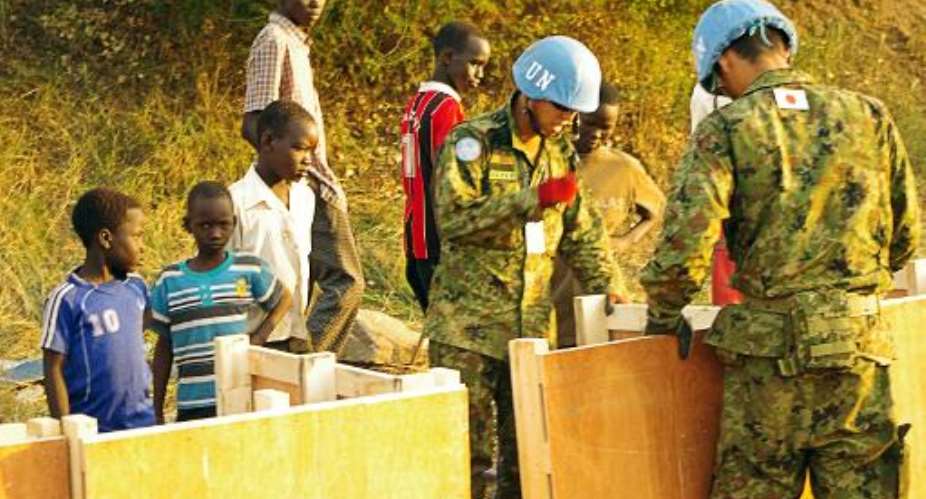A handout photo received on December 19, 2013 from UNMISS shows officers building latrines for civilians seeking refuge in the UNMISS compound on the outskirts of Juba on December 17, 2013.  By UN Military UNMISSAFP