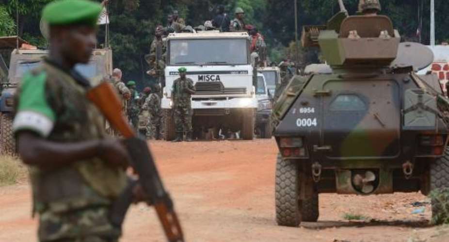 Former Seleka militants are escorted by French troops of the Sangaris operation and Rwanda's MISCA peacekeepers out of Kassai military camp in Bangui on their way to another camp outside the city on January 28, 2014.  By Issouf Sanogo AFP