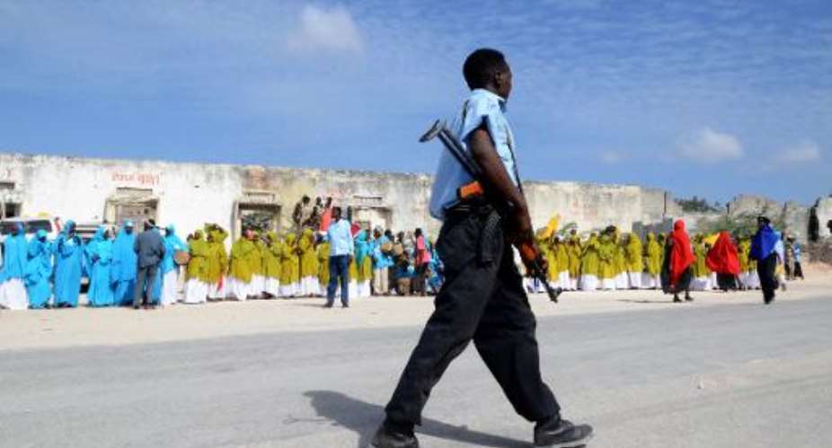A Somali policeman patrols in Mogadishu on December 9, 2011.  By Mustafa Haji Abdinur AFPFile