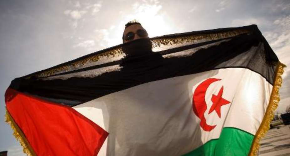 A pro-Sahrawi activist displays a Western Sahara flag as he takes part in a demonstration on December 4, 2010 in Malaga.  By Jorge Guerrero AFPFile