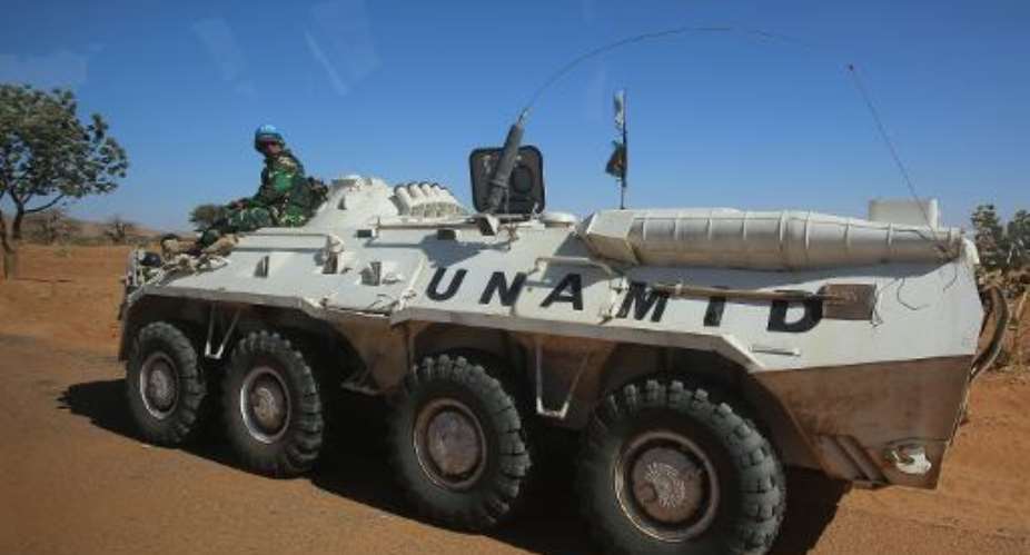 A member of the UN-African Union mission in Darfur sits on an armoured personnel carrier patrolling near the city of Nyala, January 12, 2015 in Sudan.  By Ashraf Shazly AFPFile