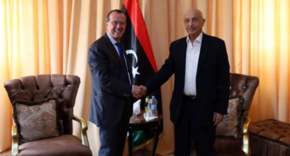 United Nations' envoy to Libya Martin Kobler L shake hands with the head of the internationally-recognised Libyan parliament, Aguila Saleh, in the eastern city of Tobruk on April 18, 2016.  By STRINGER AFPFile
