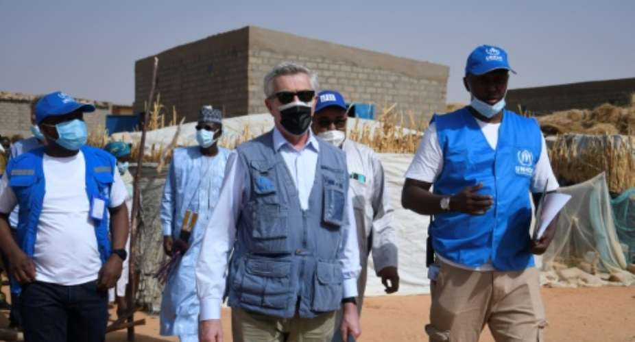 United Nations High Commissioner for Refugees Filippo Grandi examines buildings destroyed by shelling during a visit in the Ukrainian city of Kharkiv on January 24, 2023.  By SERGEY BOBOK (AFP/File)