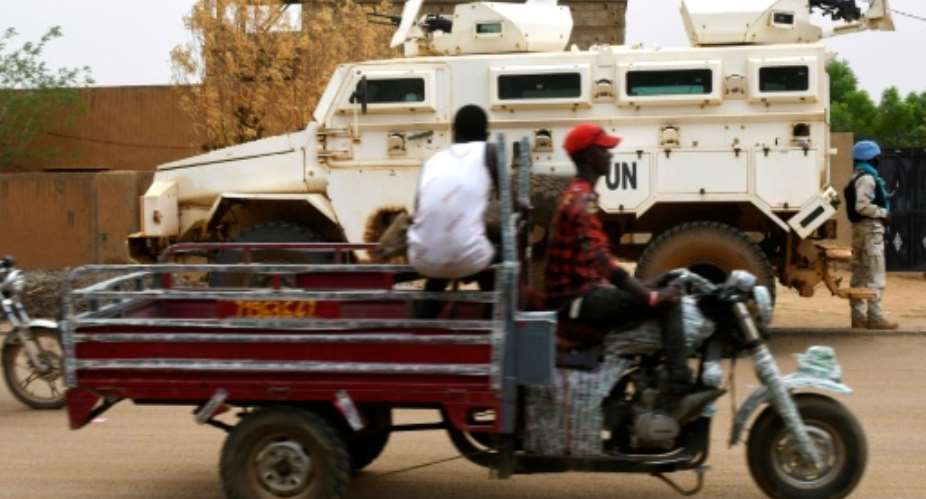 United Nations peacekeepers patrol the streets of Gao, eastern Mali in August; a peace deal between the government and armed groups was signed in 2015, but implementation has been slow and attacks have continued in the country's center and north.  By SEYLLOU AFP