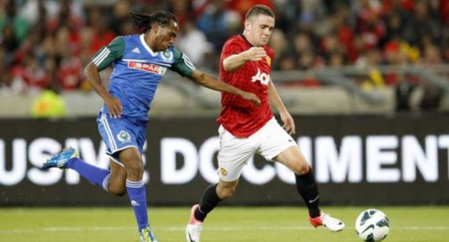 South Africa's Tsweu Mokoro L, Amazulu midfielder, and England's Scott Wootton, Manchester United defender.  By Anesh Debiky AFP