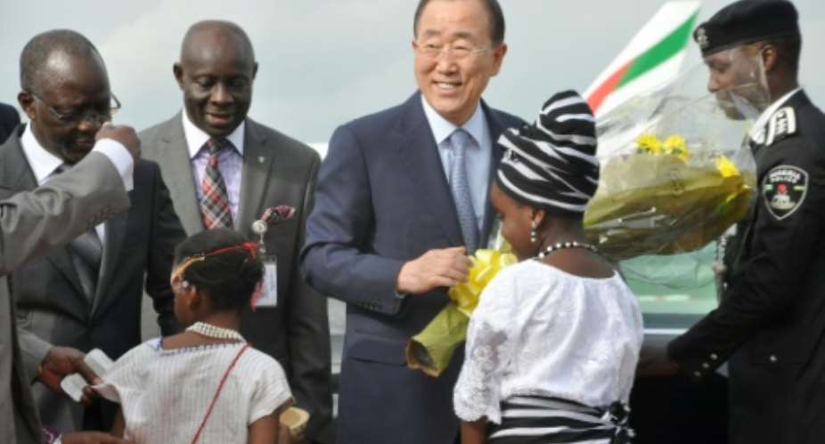 United Nations Secretary General Ban Ki-moon receives flowers from a young girl on his arrival in Abuja, on August 23, 2015.  By  AFP