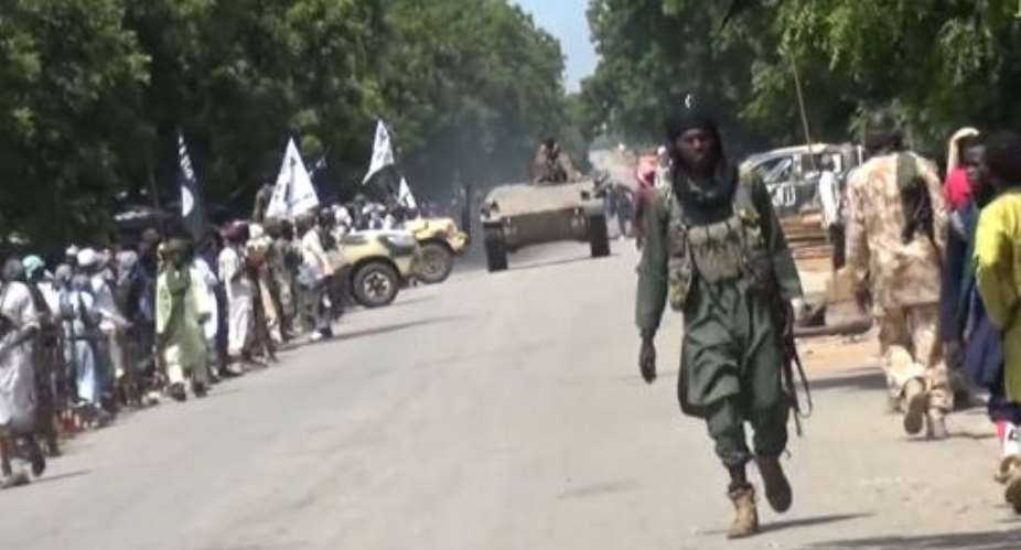 A screengrab taken on November 9, 2014 from a Boko Haram video shows the Islamic militant group's fighters parading with a tank in an unidentified town.  By  Boko HaramAFPFile