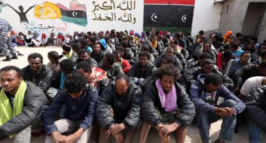 Migrants who were hoping to reach Europe by boat sit at Abu Salim detention centre for illegal migrants in Tripoli, Libya on April 21, 2015.  By Mahmud Turkia AFPFile