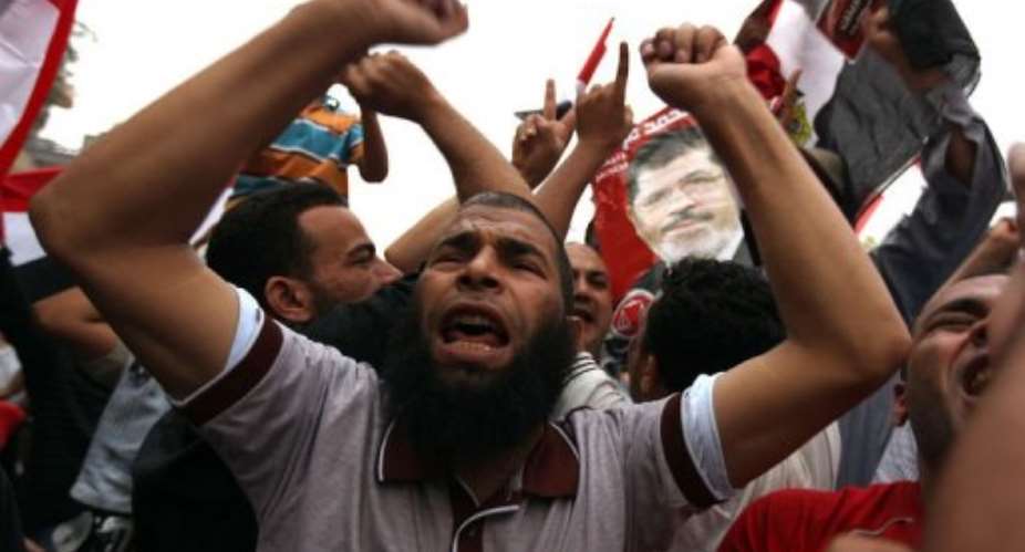 Supporters of Muslim Brotherhood candidate Mohammed Mursi celebrate in Cairo's Tahrir square.  By Patrick Baz AFP