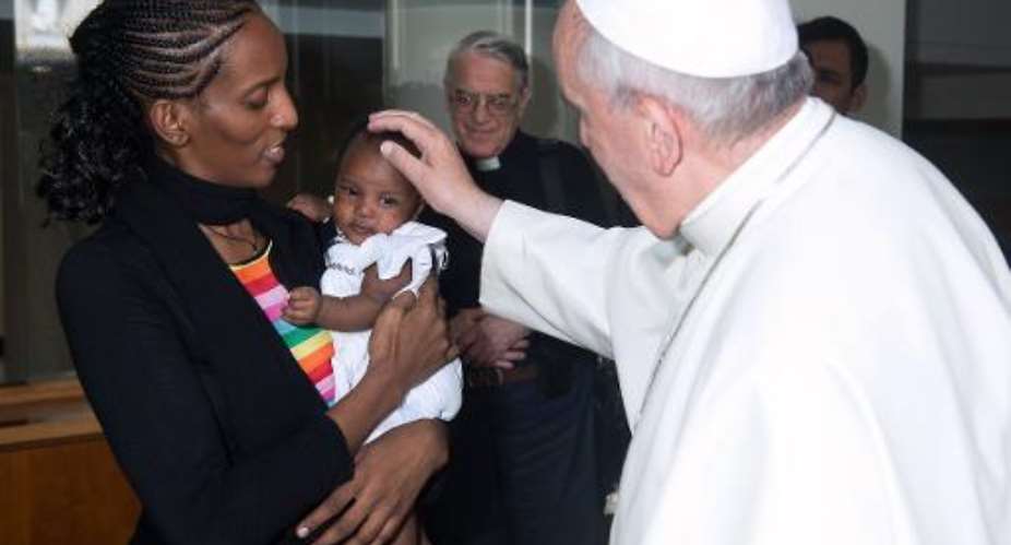 A handout photo released by the Osservatore Romano and taken on July 24, 2014 shows Pope Francis greeting Sudanese Christian Meriam Yahya Ibrahim Ishag and her daughter Maya during a private audience at the Vatican.  By  Osservatore RomanoAFP