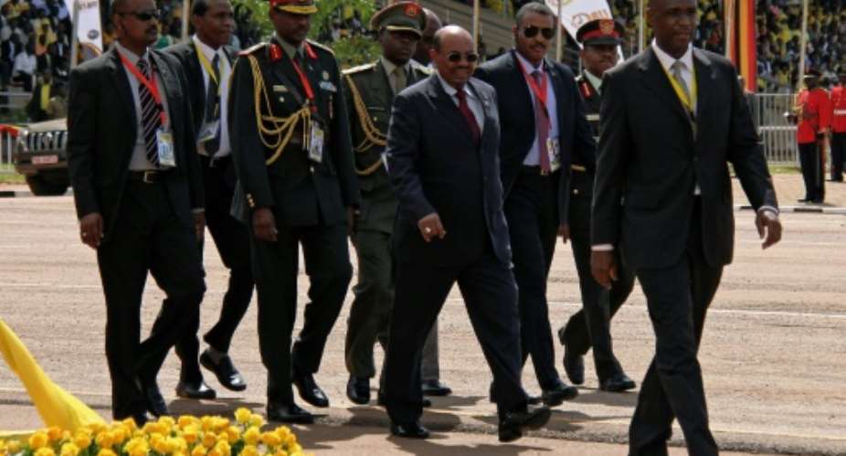 Sudan's President Omar al-Bashir C walks during the swearing in ceremony of Uganda's President Yoweri Museveni as newly elected President in Kampala on May 12, 2016.  By Gael Grilhot AFP