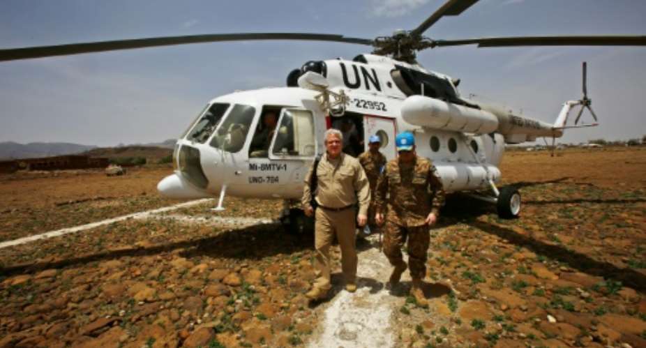 US envoy to Sudan Steven Koutsis L disembarks from a UN helicopter after landing in the war-torn town of Golo in the Jebel Marra region of central Darfur on June 19, 2017.  By ASHRAF SHAZLY AFPFile