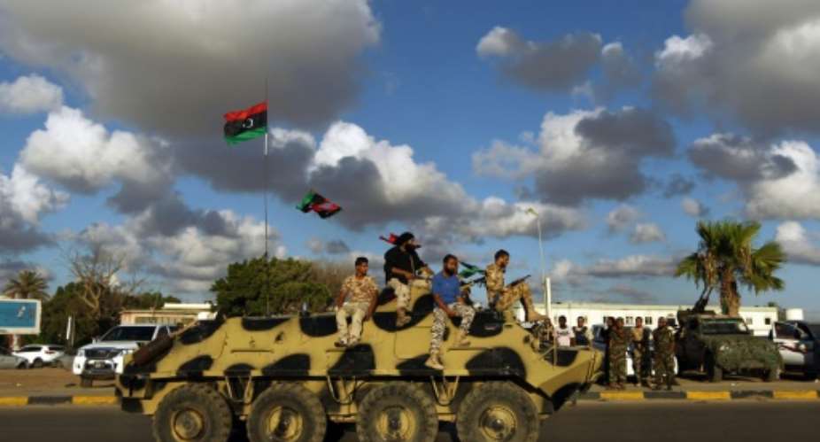 Libyan troops sit on an amoured personnel carrier during a demonstration calling on the international community to arm the Libyan army, on August 14, 2015 in Benghazi.  By Abdullah Doma AFPFile