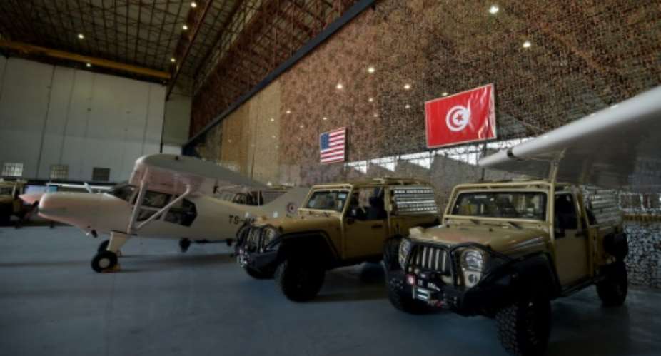 Reconnaissance aircrafts and military vehicles offered to Tunisia by the United States are seen at a military base in Tunis on May 12, 2016.  By Fethi Belaid AFP