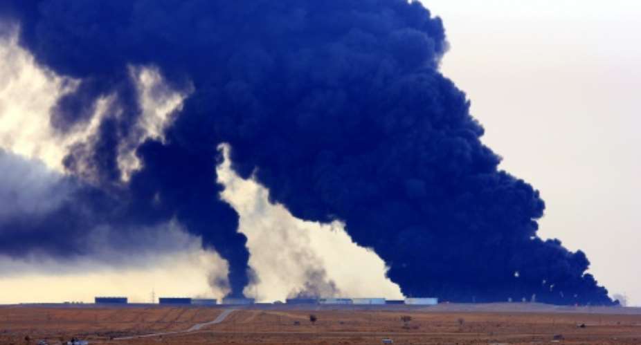 Heavy black smoke rises from an oil facility in northern Libya's Ras Lanouf region on January 23, 2016, after it caught fire following attacks launched by Islamic State group jihadists.  By  AFPFile