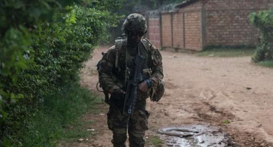 A French soldier patrols an area in the Combattant neighbourhood near the airport of Bangui, Central African Republic on December 9, 2013.  By Fred Dufour AFP